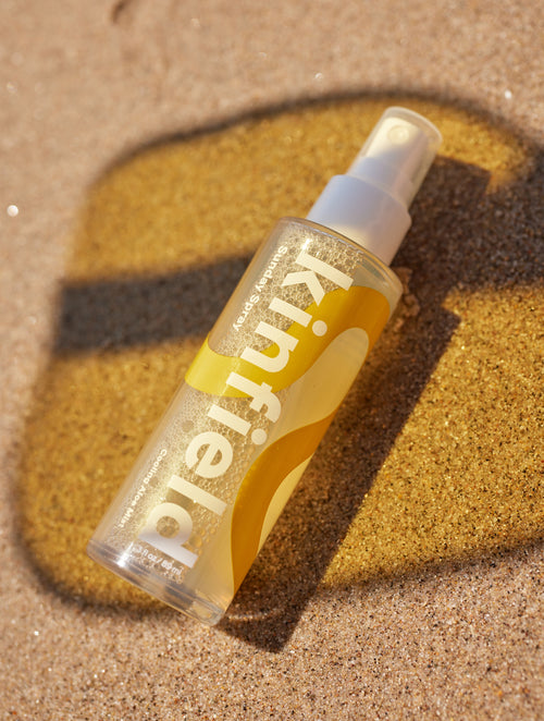 A bottle of Sunday Spray lays in the sane