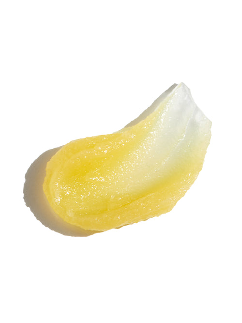 Swipe of golden-clear Lip Rescue balm on white background.